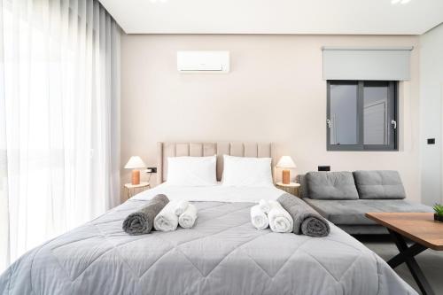 a bedroom with a large bed with towels on it at Thalori villa 2 in Psalidi