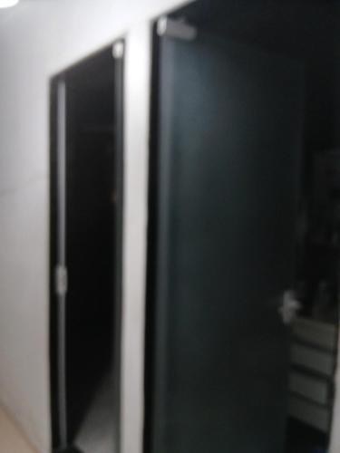 an open door to a black refrigerator in a room at Kiko Schettino in Angra dos Reis