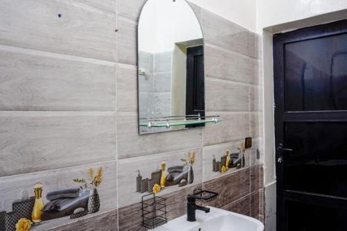 a bathroom with a sink and a mirror at oasis house in Takchrirt