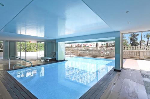 a large swimming pool in a building at Victoria Bergamote Attic with Terrace and Sea View - Happy Rentals in Menton