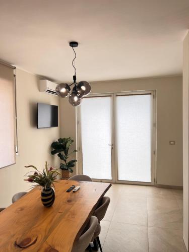 a dining room with a wooden table and chairs at Zen Apartment in Santa Maria del Cedro
