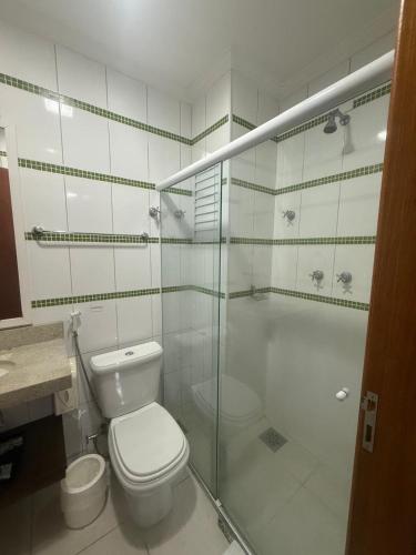 a bathroom with a toilet and a glass shower at Residencial DOM in Lorena