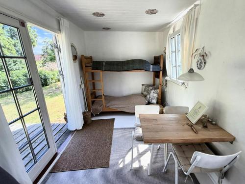 a small room with a table and a bunk bed at Nøddehaven in Eg