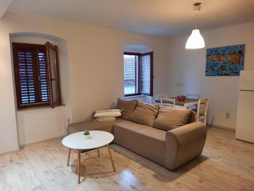 a living room with a couch and a table at Pipilota in Rijeka