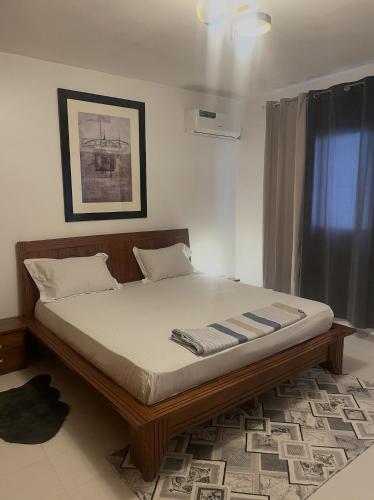 a bed sitting in a room with at RESIDENCE ADSL Studio BOUYGUES in Dakar