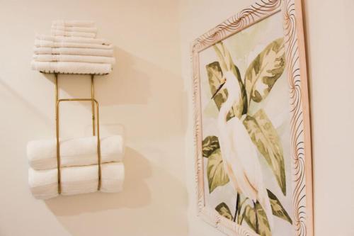 a mirror hanging on a wall next to towels at Boutique Accommodation in PEC - Suite 4 in Belleville