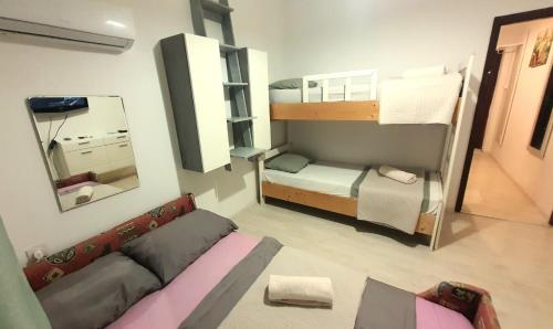 a small room with two bunk beds and a couch at UNIQUE Apartments Malinska in Malinska