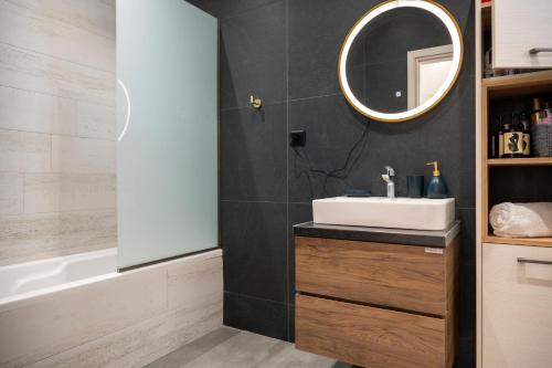 a bathroom with a sink and a mirror at Thalori villa 1 in Psalidi