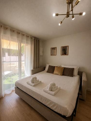 a bedroom with a large bed with towels on it at Studio hesperides in Balaruc-les-Bains