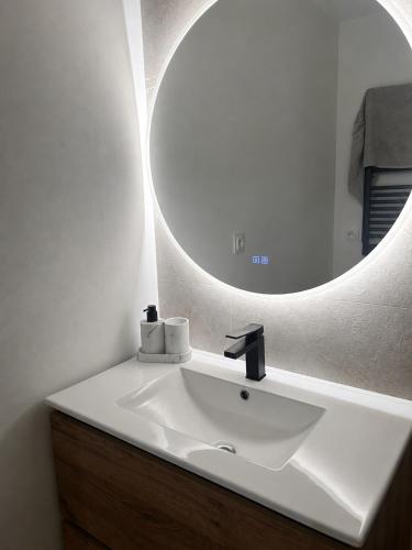 a bathroom with a white sink and a mirror at Studio hesperides in Balaruc-les-Bains