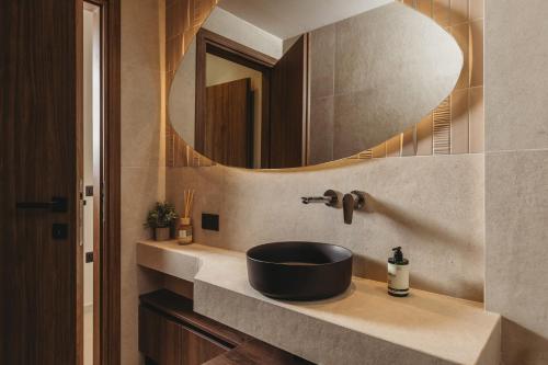 a bathroom with a sink and a mirror at Serenita luxury villa in Zakynthos