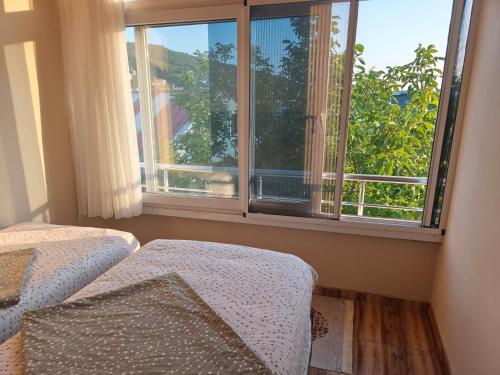 a room with a window and a bed with a view at Sağlık Apart Pansiyon in Erdek
