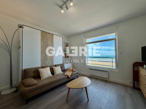 a living room with a couch and a window at GC - Au Large - Front de Mer in Wissant