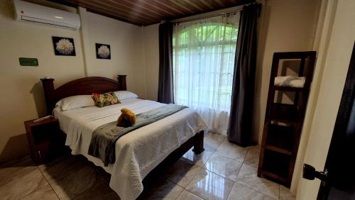 a bedroom with a bed with a cat sitting on it at Arboleda House by the River, Forest with Jacuzzi and A C in San Francisco