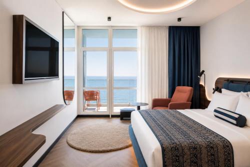 a hotel room with a bed and a large window at Spatium Medical & Wellness Hotel in Odesa