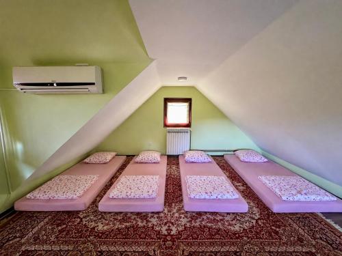 a room with four beds in a attic at Cozy Green Escape in Kakanj