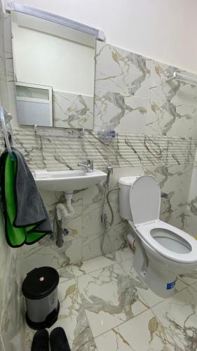 a bathroom with a toilet and a sink at Beldi apparemment in Imlil