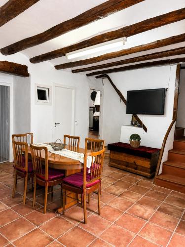 a dining room with a table and chairs and a tv at Casa Josefa Xiva Morella in Chiva de Morella