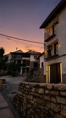 a building with a sunset in the background at Casa Josefa Xiva Morella in Chiva de Morella