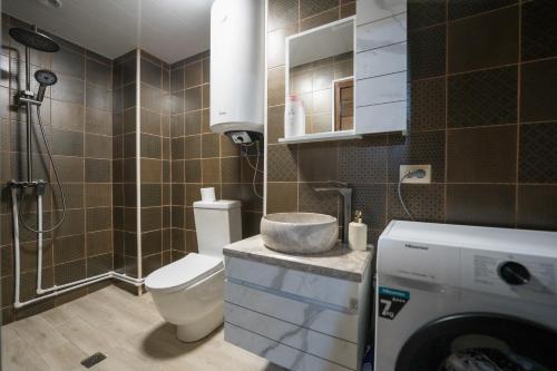 a bathroom with a toilet and a sink and a shower at Koruld Ushguli in Chvibiani