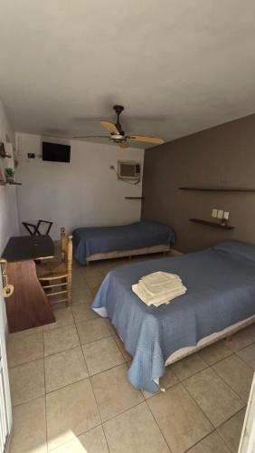 a bedroom with two beds and a table in it at Hotel barrica in Realicó