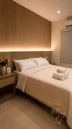 a bedroom with a large bed with towels on it at SHINY House 2 habitaciones in Clorinda