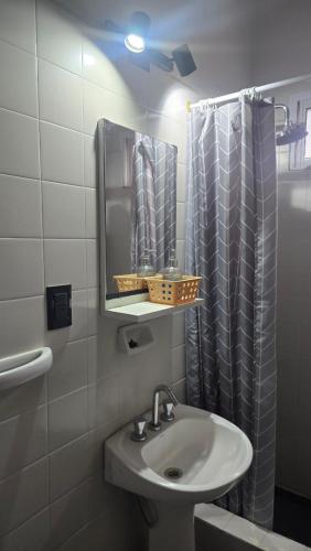 a bathroom with a sink and a shower curtain at Hotel barrica in Realicó