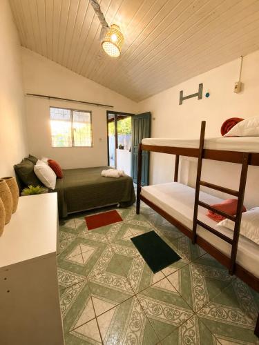 a room with a bed and a bunk bed at Casa de Alter - Hospedaria e Experiências in Alter do Chao
