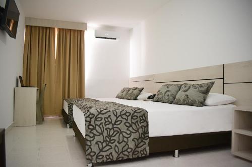 A bed or beds in a room at Hotel Kurakatá