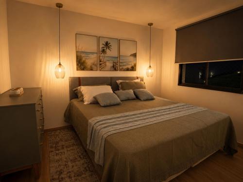 a bedroom with a large bed with two pillows at Lunar Prime Aruana in Aracaju