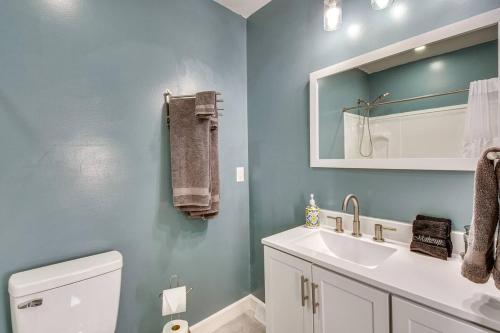 a bathroom with a white toilet and a sink at The Cottage on Corinth in Seneca