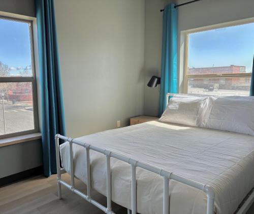 a bed in a room with a large window at Brewster Hall in Cheney