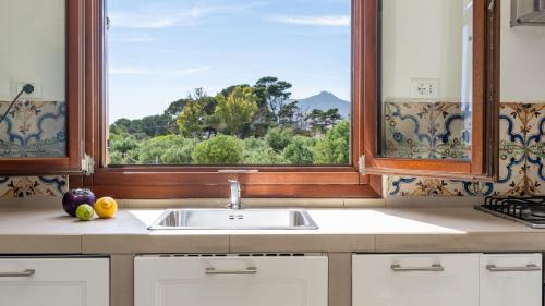 a kitchen with a sink and a window at Le Casette a Favignana in Favignana