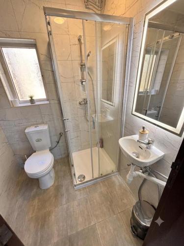 a bathroom with a shower and a toilet and a sink at Victoria Centre 2BR - Opposite Bus Terminal in Victoria