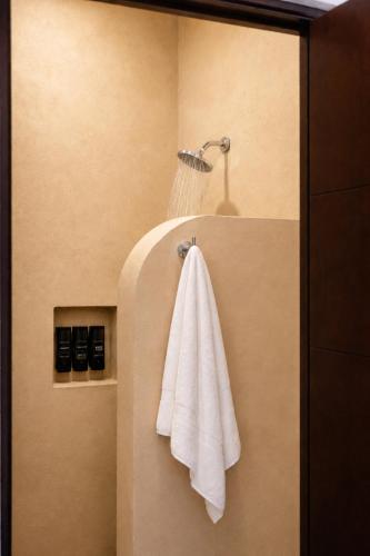 a towel hanging on a wall in a bathroom at Casa Feregrino Hotel Boutique in Cuatrociénegas de Carranza
