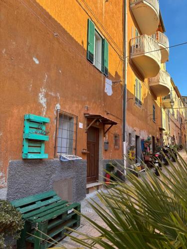 a building with a bench in front of a building at Il tuo rifugio all' Argentario in Porto Santo Stefano