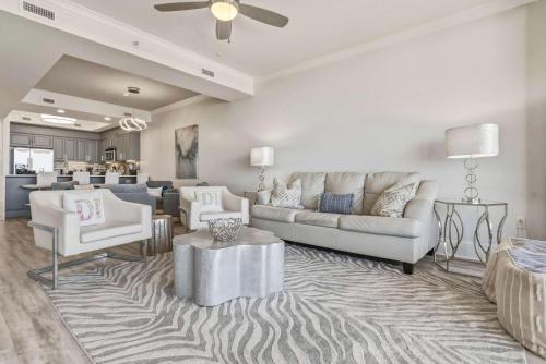 a living room with a couch and a table at Luxury GulfFront Penthouse with Resort Amenities in Dauphin Island