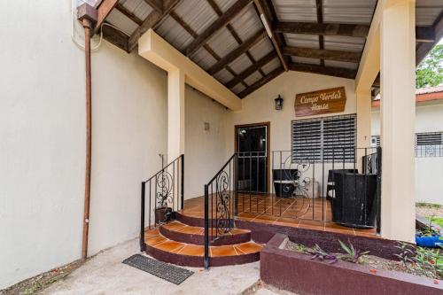a house with a staircase leading to the front door at Campo Verde House in San Ignacio