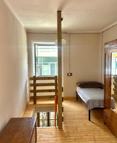 a bedroom with a bed and a window at Casa Giù Là in Quarna Sopra
