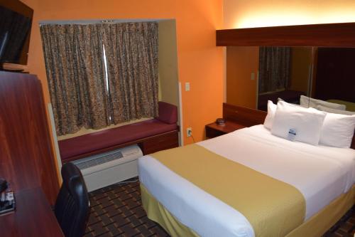 a hotel room with a bed and a window at Microtel Inn & Suites by Wyndham Rock Hill/Charlotte Area in Rock Hill