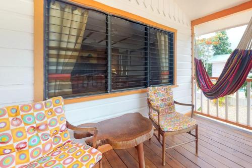 a porch with two chairs and a table and a window at Starfish Cabana at Latitude Adjustment -Gold Standard Certified in Hopkins