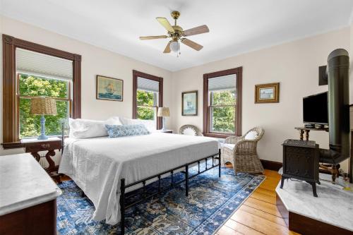 a bedroom with a bed and a flat screen tv at Inn at the Oaks in Eastham