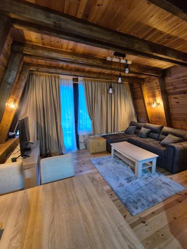 a living room with a couch and a table at Villa Evergreen Žabljak in Žabljak