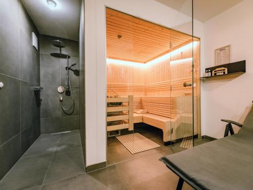 a bathroom with a sauna with a shower at Green Garden Lodge B1 in Piesendorf