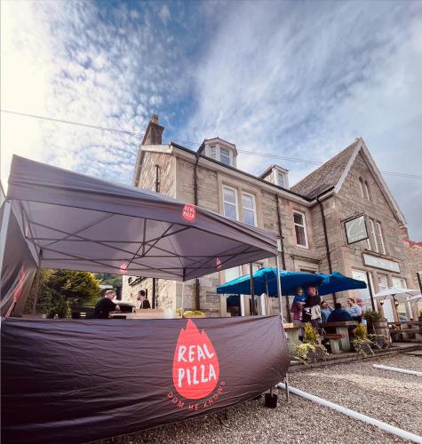 a tent is set up in front of a house at The Courie Inn in Killin