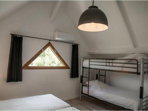 a bedroom with two bunk beds and a window at Lac Bleu 39 en 40 combi in Lacapelle-Marival
