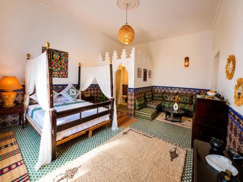 a living room with a bed and a couch at Golden house in El Jadida