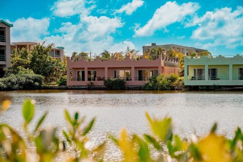 a row of houses next to a body of water at Villa 12 at Mara Laguna - Gold Standard Certified in San Pedro