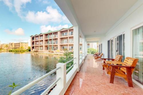a balcony with chairs and a view of the water at Villa 12 at Mara Laguna - Gold Standard Certified in San Pedro