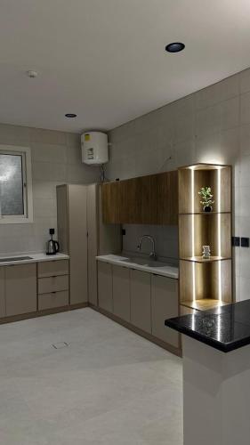 a kitchen with a stainless steel refrigerator and a counter at Rose House 2 in Taif